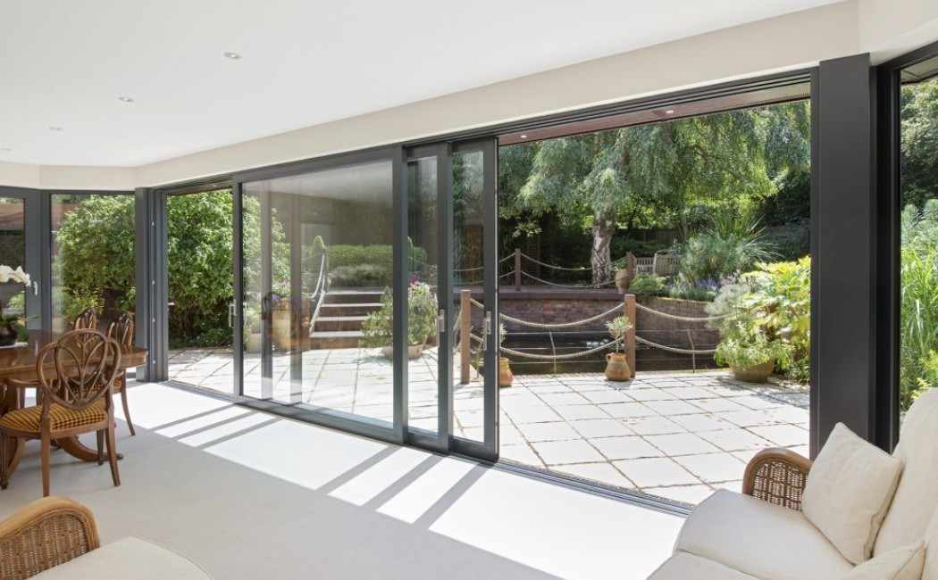 Contemporary patio door installation featuring wide sliding glass doors that create a seamless transition between the living area and outdoor patio.