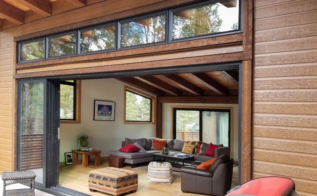 Modern patio door installation featuring a wide open sliding glass door that seamlessly connects a contemporary living room to an outdoor patio.