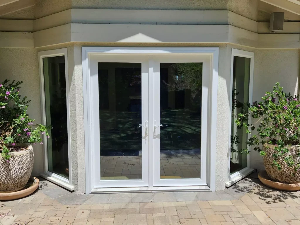 Patio Door Installation featuring elegant double glass doors that enhance outdoor access and natural light.