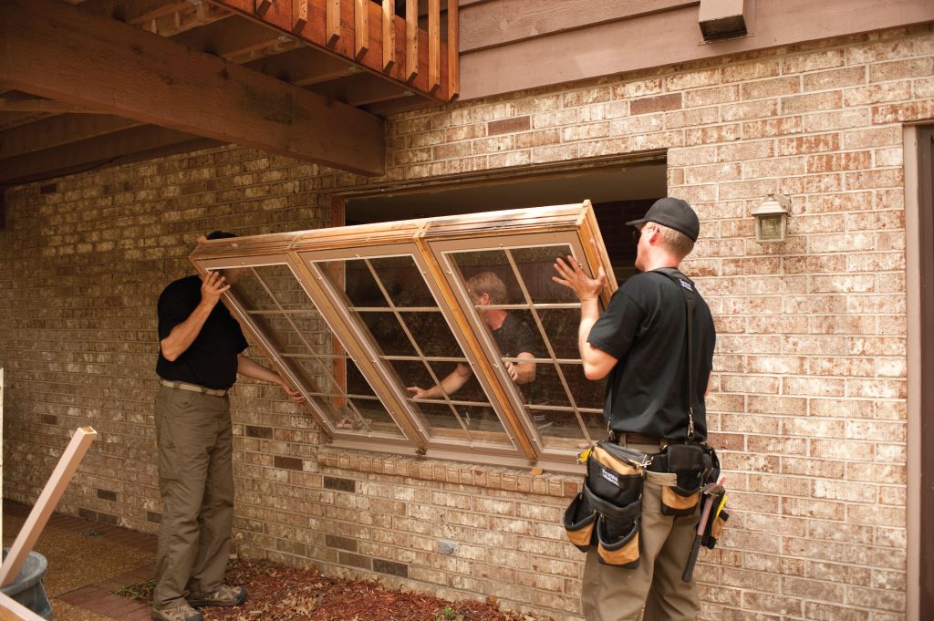 Window Installation Services with a professional team carefully installing a large residential window for enhanced comfort and natural light.