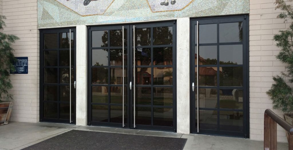 Commercial Door Installation with Black-Framed Glass Double Doors Commercial Door Installation showcasing sleek black-framed glass double doors with matching sidelights, durable hardware, and a modern commercial entrance.